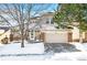 Inviting two-story home with attached garage and well-maintained lawn during winter at 958 Bramblewood Dr, Castle Pines, CO 80108