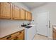 Laundry room with washer, dryer, and ample cabinetry at 958 Bramblewood Dr, Castle Pines, CO 80108