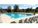 Large community pool with plenty of deck space and lounge chairs at 958 Bramblewood Dr, Castle Pines, CO 80108