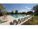 Community pool with plenty of lounge chairs and umbrellas at 958 Bramblewood Dr, Castle Pines, CO 80108