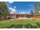Brick home backyard featuring a covered patio, perfect for outdoor living and entertainment at 2986 W Union Ave, Englewood, CO 80110