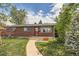 Charming brick home featuring a well-manicured lawn, inviting walkway, and freshly painted trim at 2986 W Union Ave, Englewood, CO 80110
