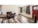 Cozy living room featuring wood-look floors, a comfortable recliner, and ample natural light at 2986 W Union Ave, Englewood, CO 80110