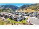 Aerial view of houses nestled among rolling hills and mountains, with lush lawns and fences in backyard at 15773 Timber Trek Way, Monument, CO 80132