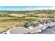 Aerial view of homes on a cul-de-sac, adjacent to a field of green, and with rolling mountains in the background at 15773 Timber Trek Way, Monument, CO 80132