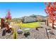 Expansive backyard with colorful trees, landscaping, and Adirondack chairs to enjoy views of the mountains at 15773 Timber Trek Way, Monument, CO 80132