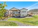 Backyard with two-story home, a patio underneath a deck, a lush lawn, and mountain views at 15773 Timber Trek Way, Monument, CO 80132