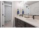 Double vanity bathroom with dark wood cabinets, modern fixtures, and shower at 15773 Timber Trek Way, Monument, CO 80132