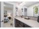 Bathroom features a dark wood vanity, modern fixtures, decorative mirror, and tiled floors at 15773 Timber Trek Way, Monument, CO 80132