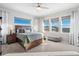 Bright bedroom with a large bed, neutral colors, and expansive windows with scenic views at 15773 Timber Trek Way, Monument, CO 80132