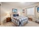 Comfortable bedroom with a plaid bedspread and two side tables and lamps at 15773 Timber Trek Way, Monument, CO 80132