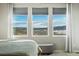 Bright bedroom view featuring three large windows with scenic mountain views and tasteful interior decor at 15773 Timber Trek Way, Monument, CO 80132