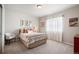 Cozy bedroom with neutral colors, comfortable bedding, and natural light from the window at 15773 Timber Trek Way, Monument, CO 80132