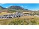 An aerial view shows the community nestled in a natural landscape with mountain views and open space at 15773 Timber Trek Way, Monument, CO 80132