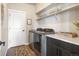 Laundry room with modern washer and dryer, built-in cabinets, and ample storage space at 15773 Timber Trek Way, Monument, CO 80132