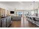 Open-concept living space with island seating, a fireplace, and lots of windows that let in natural light at 15773 Timber Trek Way, Monument, CO 80132