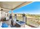 Covered patio with cushioned seating around a fire pit and beautiful views of the rolling hills beyond at 15773 Timber Trek Way, Monument, CO 80132