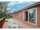 Back deck with chairs, brick facade, and sliding glass doors at 12030 W Alameda Pkwy, Lakewood, CO 80228