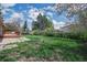 Expansive backyard with green lawn and partial view of deck, perfect for outdoor relaxation at 12030 W Alameda Pkwy, Lakewood, CO 80228