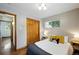 Cozy bedroom featuring hardwood floors, closet with wood doors and warm decor at 12030 W Alameda Pkwy, Lakewood, CO 80228