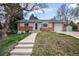 Charming ranch-style home featuring a brick facade, gray siding, and a well-maintained front yard at 12030 W Alameda Pkwy, Lakewood, CO 80228