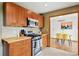 Contemporary kitchen with stainless steel appliances, wood cabinetry, and open layout ideal for cooking and entertaining at 12030 W Alameda Pkwy, Lakewood, CO 80228