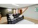 Spacious living room with carpet flooring featuring a leather sofa, and neutral decor at 12030 W Alameda Pkwy, Lakewood, CO 80228