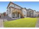 Home exterior with a large green backyard, an outdoor patio, and a wooden deck at 26731 E Hinsdale Pl, Aurora, CO 80016