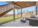 Outdoor patio area with lounge seating and views of the fenced backyard and neighboring houses at 26731 E Hinsdale Pl, Aurora, CO 80016