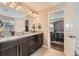 A dual vanity bathroom features granite counters, dark cabinets and opens to bedroom at 26731 E Hinsdale Pl, Aurora, CO 80016