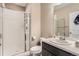 Bathroom featuring a glass shower, a white toilet, and a vanity with dark cabinetry at 26731 E Hinsdale Pl, Aurora, CO 80016
