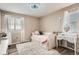 Well-lit bedroom with a daybed, white furniture, and neutral walls at 26731 E Hinsdale Pl, Aurora, CO 80016