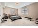 Bedroom with a large bed with a patterned bedspread, two windows and workout equipment at 26731 E Hinsdale Pl, Aurora, CO 80016