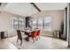 Dining room with a rustic wood table, modern light fixture, and natural light at 26731 E Hinsdale Pl, Aurora, CO 80016