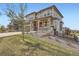 Charming two-story home with well-maintained lawn and stone details on the facade at 26731 E Hinsdale Pl, Aurora, CO 80016