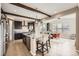 Kitchen boasts dark wood cabinets, a spacious island, and modern stainless steel appliances at 26731 E Hinsdale Pl, Aurora, CO 80016