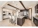 Open kitchen with granite island, dark wood accents, stainless appliances and an open floor plan at 26731 E Hinsdale Pl, Aurora, CO 80016