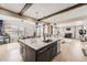 Bright, open kitchen featuring a large island, modern appliances, and views into the living and dining areas at 26731 E Hinsdale Pl, Aurora, CO 80016