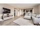 Living room with open floorplan showing kitchen and dark wood accents at 26731 E Hinsdale Pl, Aurora, CO 80016