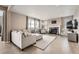 Bright and airy living room with a cozy fireplace and plush furnishings at 26731 E Hinsdale Pl, Aurora, CO 80016