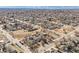 Expansive aerial view showcasing numerous homes with snow-capped mountains visible in the distance at 901 S Osceola St, Denver, CO 80219