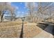 Fenced backyard with sparse vegetation, demonstrating outdoor space and privacy at 901 S Osceola St, Denver, CO 80219