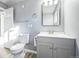 Bathroom featuring a gray vanity, modern fixtures, and updated toilet and hardware at 901 S Osceola St, Denver, CO 80219