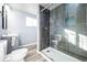 Modern bathroom featuring a glass shower with gray tiling and updated fixtures at 901 S Osceola St, Denver, CO 80219