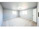 Light-filled bedroom with plush carpeting, neutral walls, and two windows at 901 S Osceola St, Denver, CO 80219