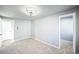 Light and airy bedroom with neutral paint, updated light fixture, and plush carpeting at 901 S Osceola St, Denver, CO 80219