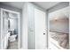 Hallway leading to a full bathroom and a sunlit living area at 901 S Osceola St, Denver, CO 80219