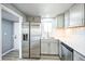 Well-equipped kitchen with stainless steel refrigerator and modern appliances at 901 S Osceola St, Denver, CO 80219