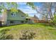 Large grassy backyard features the home's exterior and covered patio at 845 S Kenton St, Aurora, CO 80012
