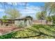 Charming backyard with storage shed, grass and landscaping at 845 S Kenton St, Aurora, CO 80012